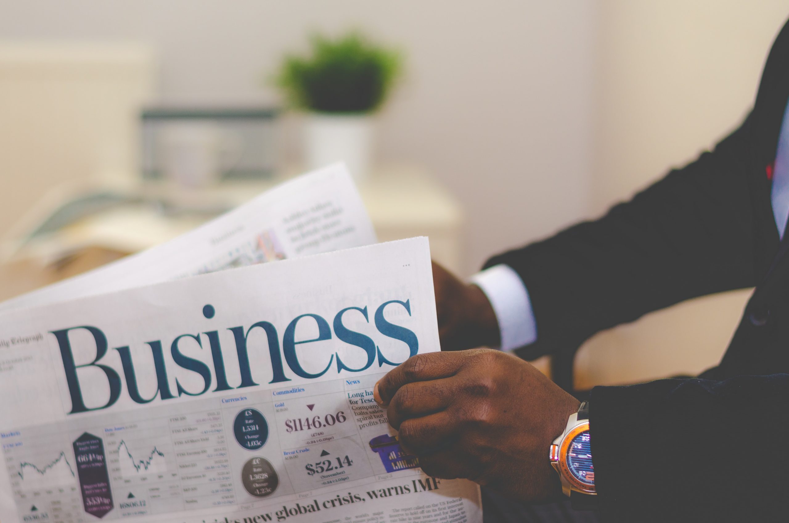 man reading business section of paper